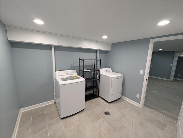 washroom featuring washer and clothes dryer, baseboards, and recessed lighting