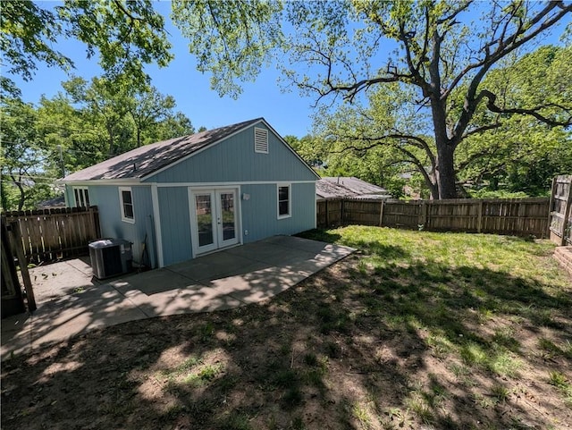 rear view of property featuring french doors, cooling unit, and a patio