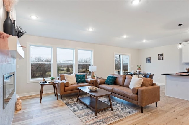 1925 SW Merryman Dr, Lees Summit, MO 64082 - living area with light wood-style floors, baseboards, recessed lighting, and a tiled fireplace