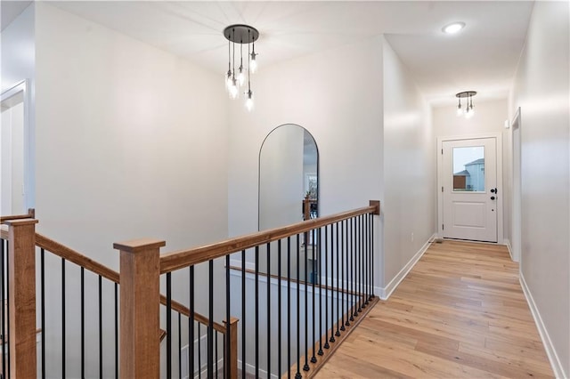 1925 SW Merryman Dr, Lees Summit, MO 64082 - hall featuring light wood finished floors, an upstairs landing, baseboards, and recessed lighting
