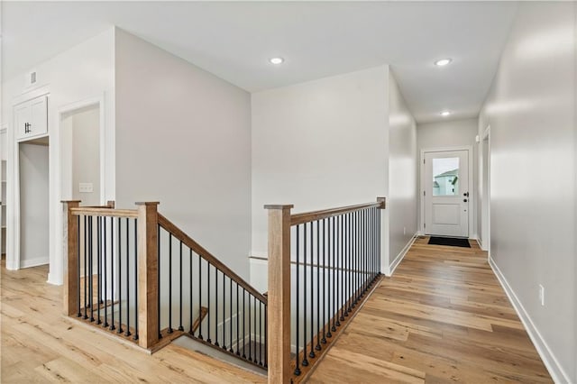 1925 SW Merryman Dr, Lees Summit, MO 64082 - hallway with an upstairs landing, light wood-style flooring, recessed lighting, and baseboards