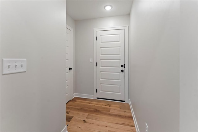 1925 SW Merryman Dr, Lees Summit, MO 64082 - doorway to outside featuring light wood-style flooring and baseboards