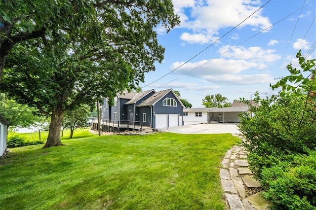 19P Lake Shore Dr, Lake Lotawana, MO 64086 - back of house featuring a garage, driveway, a yard, and stucco siding