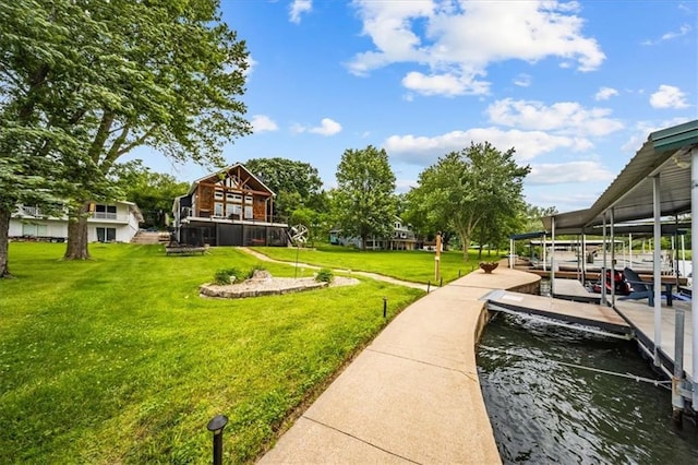 19P Lake Shore Dr, Lake Lotawana, MO 64086 - view of grassy yard with a boat dock, boat lift, and a water view