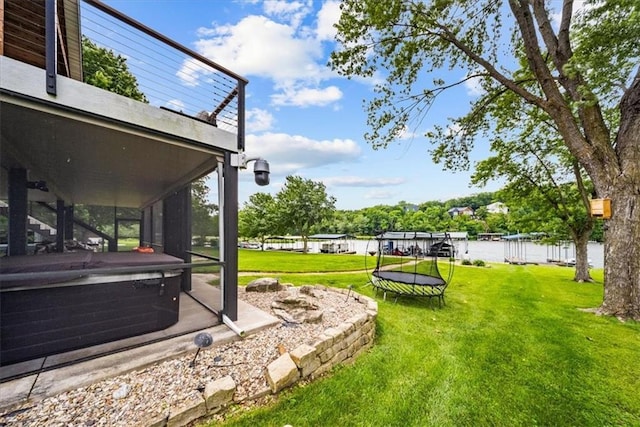 19P Lake Shore Dr, Lake Lotawana, MO 64086 - view of grassy yard with a trampoline and a hot tub