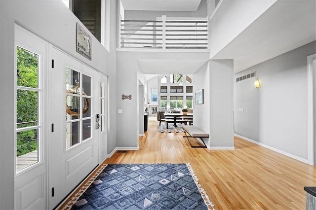 19P Lake Shore Dr, Lake Lotawana, MO 64086 - entryway with wood finished floors, plenty of natural light, and a high ceiling