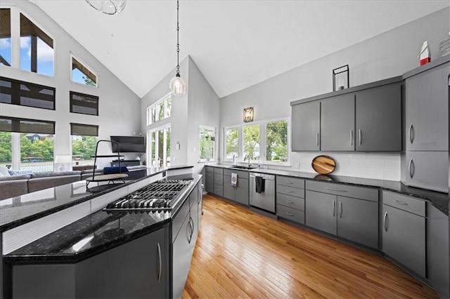 19P Lake Shore Dr, Lake Lotawana, MO 64086 - kitchen featuring appliances with stainless steel finishes, high vaulted ceiling, gray cabinets, light wood-style flooring, and dark stone counters