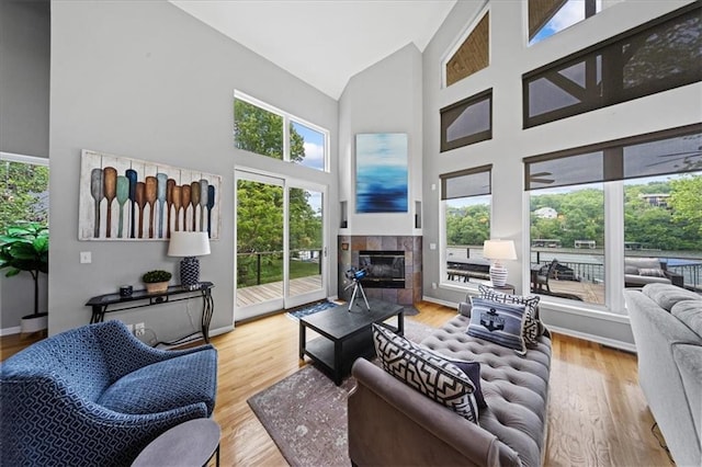 19P Lake Shore Dr, Lake Lotawana, MO 64086 - living room featuring high vaulted ceiling, healthy amount of natural light, a fireplace, and wood finished floors