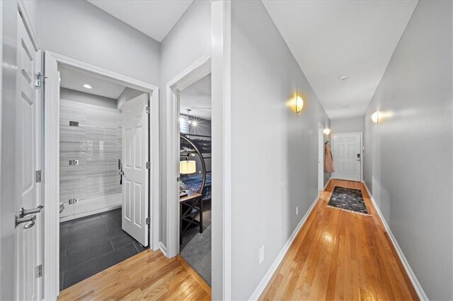 19P Lake Shore Dr, Lake Lotawana, MO 64086 - hallway featuring wood finished floors and baseboards