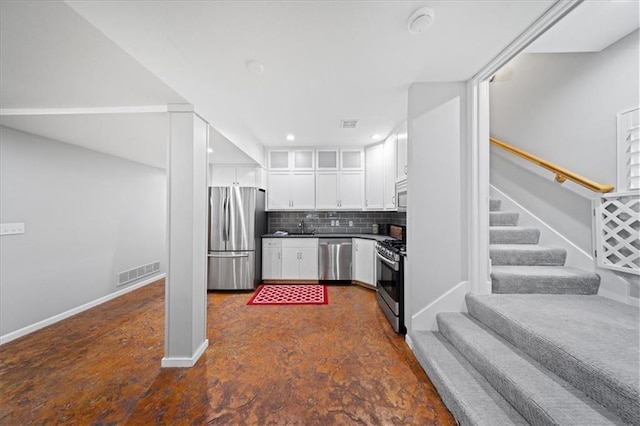 19P Lake Shore Dr, Lake Lotawana, MO 64086 - kitchen featuring appliances with stainless steel finishes, backsplash, white cabinets, dark countertops, and recessed lighting