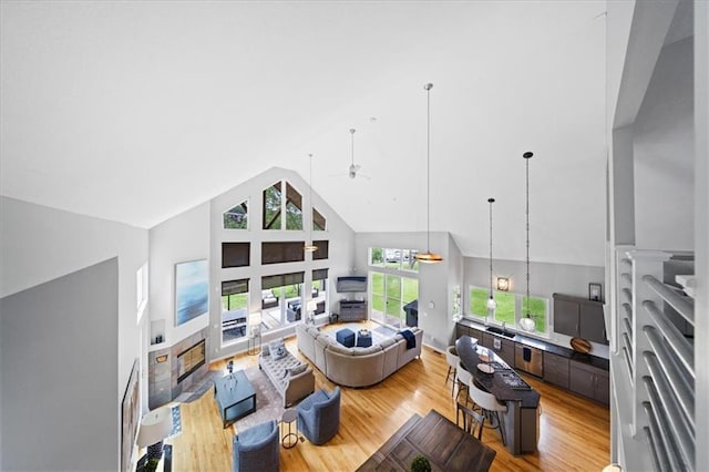 19P Lake Shore Dr, Lake Lotawana, MO 64086 - living room with a ceiling fan, high vaulted ceiling, and wood finished floors