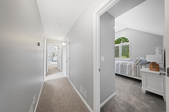 19P Lake Shore Dr, Lake Lotawana, MO 64086 - corridor with lofted ceiling, carpet floors, and healthy amount of natural light