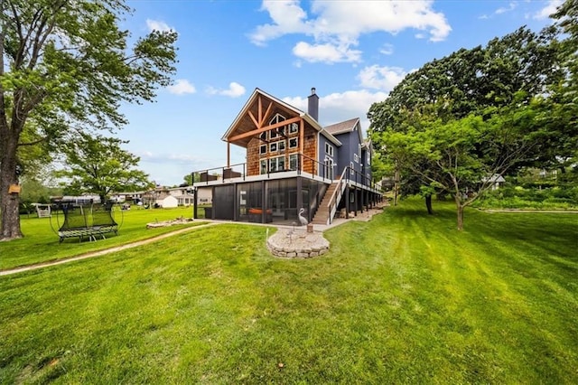 19P Lake Shore Dr, Lake Lotawana, MO 64086 - back of house with stairway, a lawn, a chimney, a deck, and an attached garage