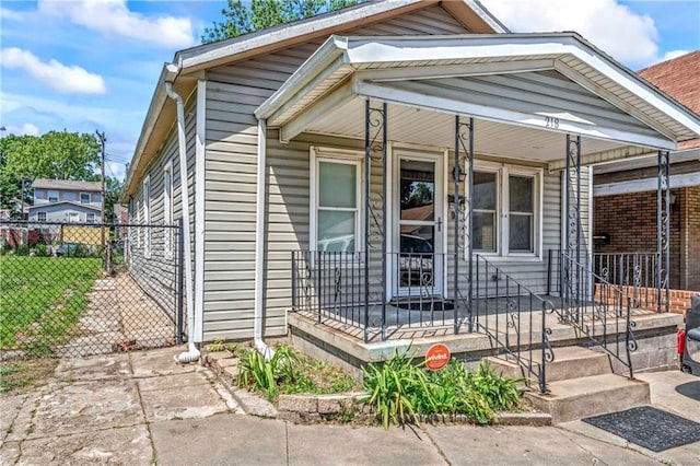 218 S 8th St, Kansas City, KS 66101 - shotgun-style home with fence and a porch