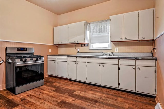 218 S 8th St, Kansas City, KS 66101 - kitchen featuring stainless steel gas stove, dark countertops, white cabinets, and dark wood finished floors