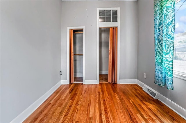 218 S 8th St, Kansas City, KS 66101 - unfurnished bedroom featuring wood finished floors and baseboards