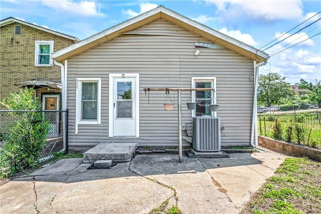 218 S 8th St, Kansas City, KS 66101 - back of house featuring central AC, fence, and a patio area