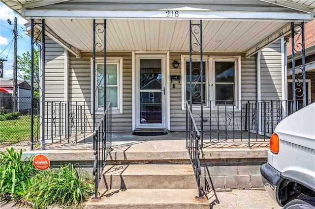 218 S 8th St, Kansas City, KS 66101 - view of exterior entry with a porch and fence