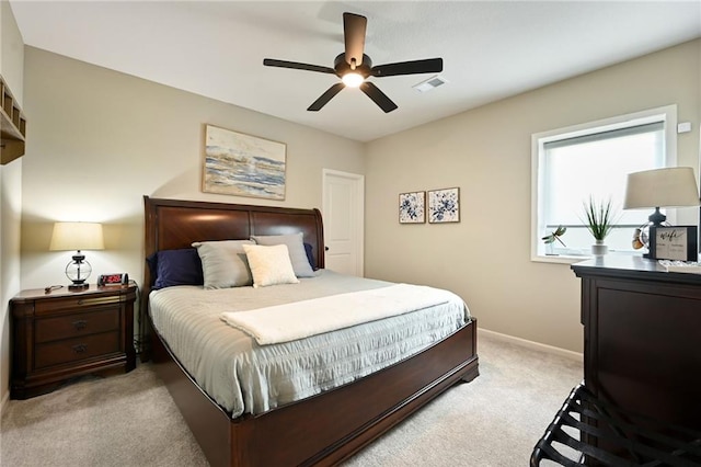 bedroom with light carpet, baseboards, and a ceiling fan