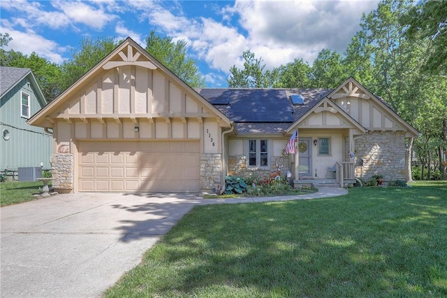 1136 SE 7th St, Lees Summit, MO 64063 - view of front facade with stone siding, a front yard, a garage, and roof mounted solar panels