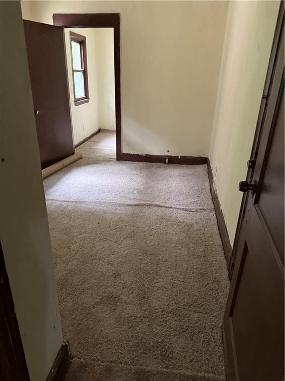 2735 Askew Ave, Kansas City, MO 64128 - carpeted empty room with baseboards