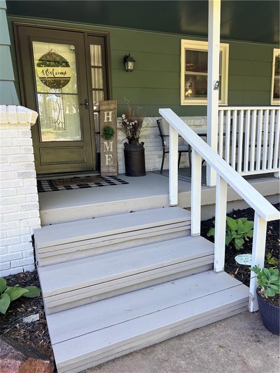 view of exterior entry with covered porch