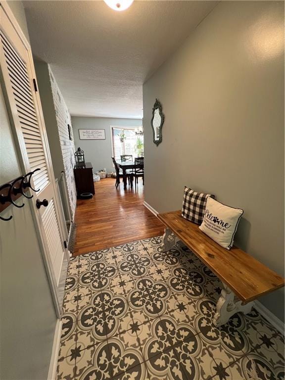 corridor with baseboards and wood finished floors