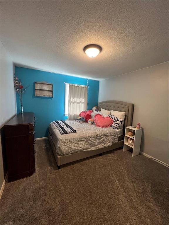 carpeted bedroom with a textured ceiling and baseboards