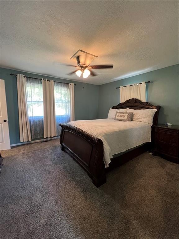 carpeted bedroom featuring a textured ceiling and a ceiling fan