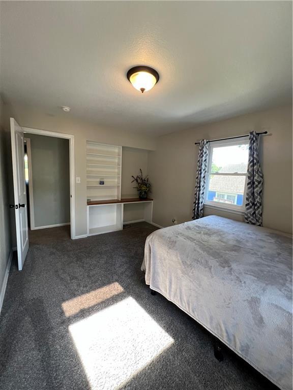 bedroom featuring carpet and baseboards