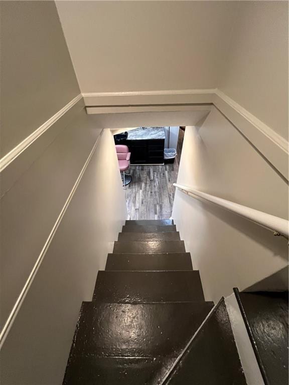 staircase featuring wood finished floors