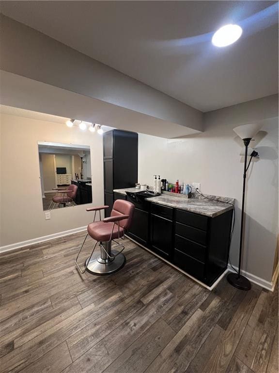 bar area with dark wood-type flooring and baseboards