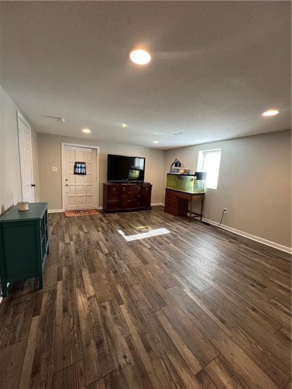 unfurnished living room featuring dark wood-style floors, baseboards, and recessed lighting