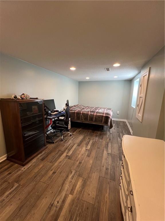 bedroom with dark wood-style floors, recessed lighting, and baseboards