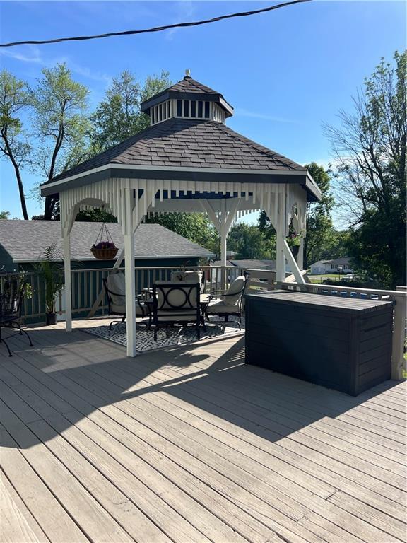 wooden terrace featuring a gazebo