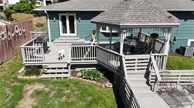 wooden deck featuring a gazebo, central AC unit, and stairs