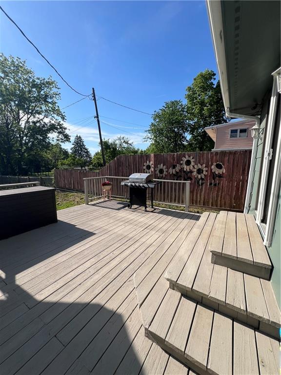 deck featuring grilling area and a fenced backyard