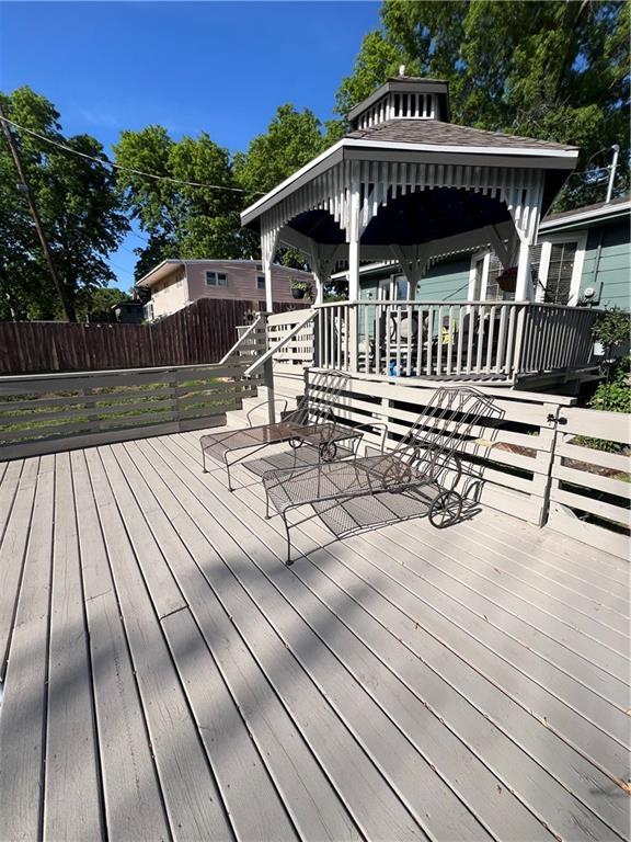 deck featuring fence and a gazebo