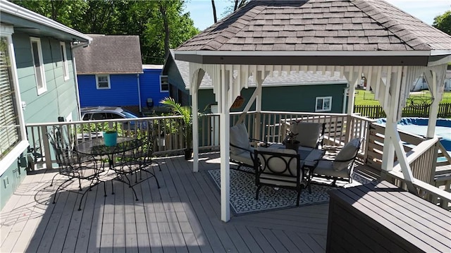 deck with outdoor dining space and a gazebo