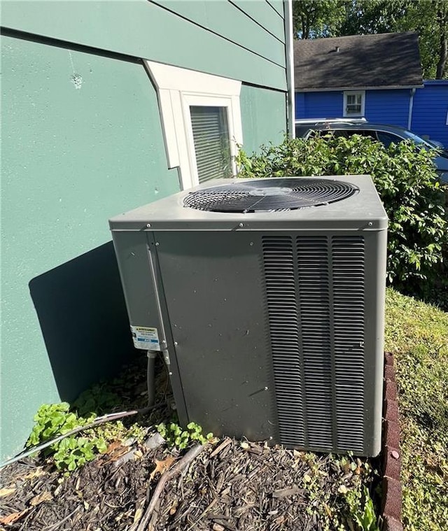 exterior view of central air condition unit and stucco siding