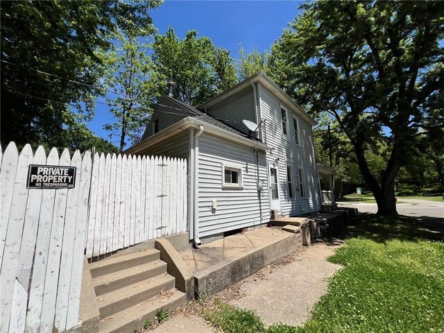 view of home's exterior with fence