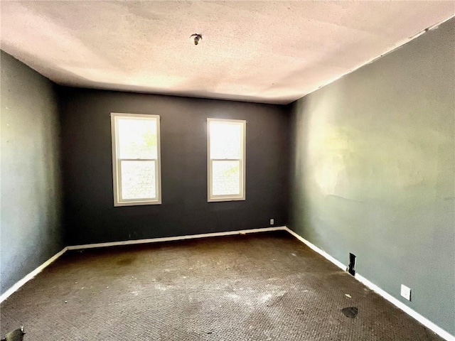 carpeted empty room with baseboards