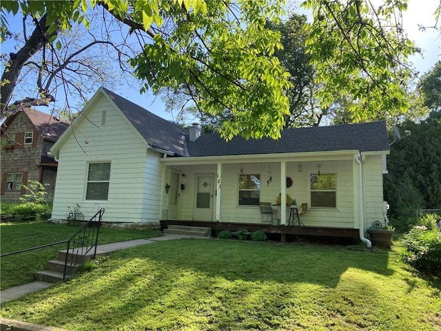 121 S Willis Ave, Independence, MO 64050 - view of front of house with a front lawn, a porch, roof with shingles, and a chimney