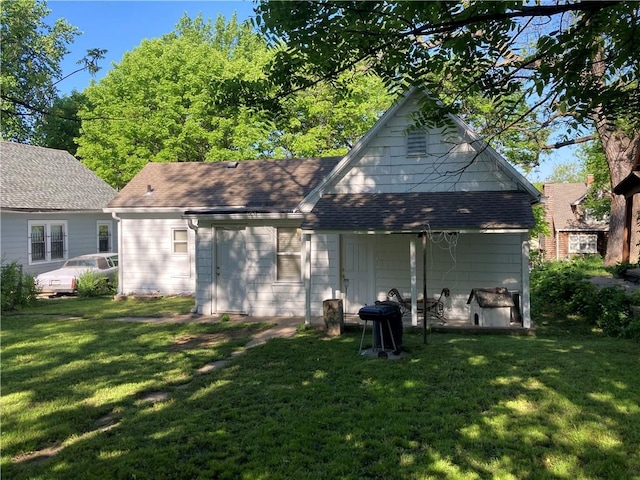 121 S Willis Ave, Independence, MO 64050 - back of house with a lawn and a shingled roof