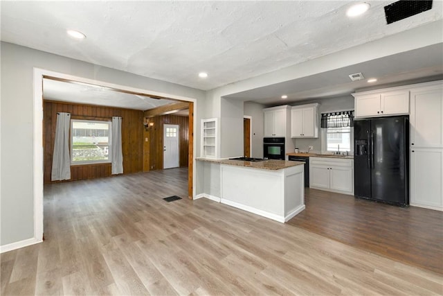 2409 Oakley Ave, Kansas City, MO 64127 - kitchen with black appliances, a sink, white cabinets, baseboards, and recessed lighting