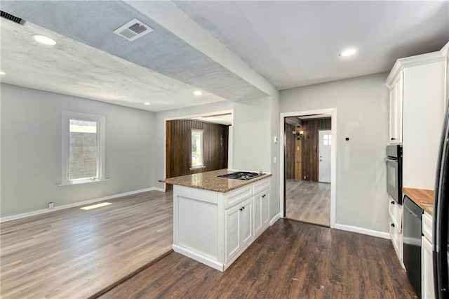 2409 Oakley Ave, Kansas City, MO 64127 - kitchen with white cabinets, recessed lighting, a peninsula, dark wood-style flooring, and baseboards