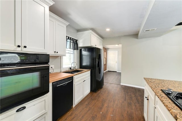 2409 Oakley Ave, Kansas City, MO 64127 - kitchen featuring black appliances, a sink, dark wood finished floors, white cabinets, and recessed lighting