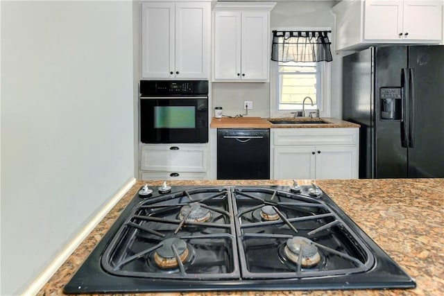 2409 Oakley Ave, Kansas City, MO 64127 - kitchen featuring black appliances, a sink, and white cabinetry