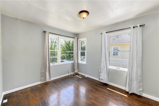 2409 Oakley Ave, Kansas City, MO 64127 - unfurnished room featuring wood-type flooring and baseboards