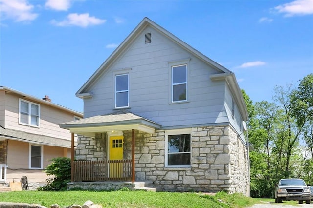 2409 Oakley Ave, Kansas City, MO 64127 - view of front of property with stone siding and a front yard